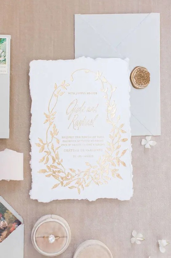 a refined and chic raw edge wedding invitation with gold foil letters and leaves is a lovely idea for a sophisticated wedding