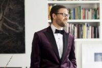 a refined groom’s look with a purple velvet blazer with black lapels, a black bow tie and black pants