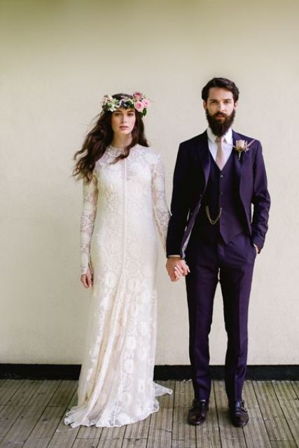 a sophisticated groom's outfit with a deep purple three-piece pantsuit, a white shirt, a blush tie and a boutonniere