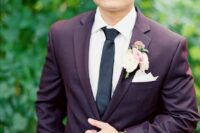 a modern groom’s attire with a fall boutonniere