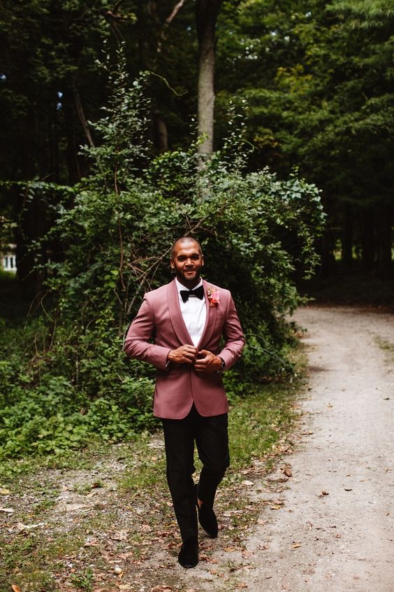 a stylish groom's look with a white shirt, black trousers, black loafers and a bow tie, a mauve velvet blazer