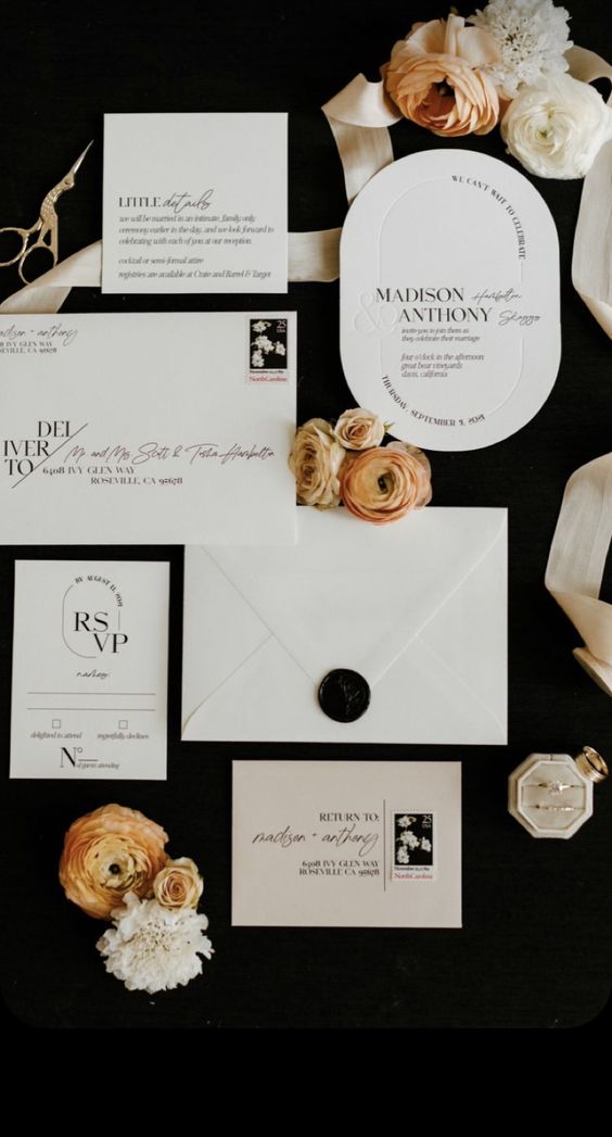 a stylish neutral wedding invitation suite with black lettering and a black seal for a modern wedding