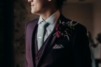 a stylish purple three-piece groom’s suit, a neutral shirt, a light grey tie and a bold boutonniere for the fall