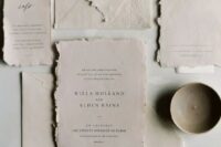 a vintage wedding invitation suite with a deckle edge and a textured envelope