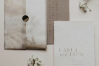 an elegant wedding invitation suite with a neutral envelope, a white and a taupe card plus letter pressing