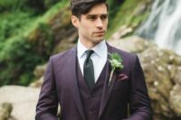 an exquisite groom’s look with a purple three-piece pantsuit, a white shirt, a black tie and a greenery boutonniere