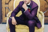 an eye-catching groom’s look with a purple suit, a white shirt, a black bow tie, black shoes and a bold boutonniere