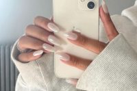 long almond-shaped pearly white nails are the newest and top idea for a bride, they look chic and shiny