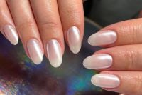 shimmery pearl nails of an almond shape are amazing for a wedding, they look shiny, chic and relaxed