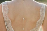 a back lariat necklace with a moonstone and a pearl is a catchy idea and a chic way to accent your open back