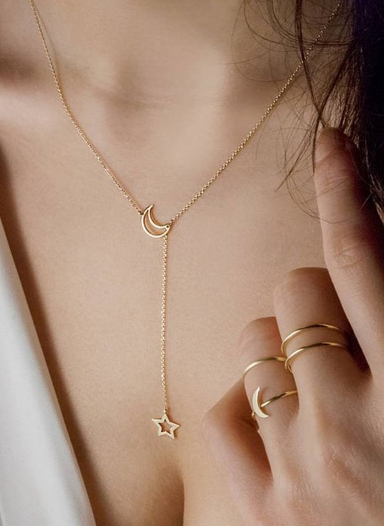 a celestial gold lariat necklace with a half moon and a star for a delicate touch to your outfit