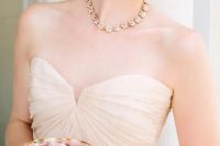 a gold floral necklace like this one plus a matching bracelet will give a delicate and chic touch to your bridal look