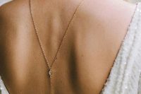 a minimalist back necklace with a duo of diamonds is a chic idea that can be worn to a special occasion