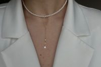 a pearl choker with a dainty chain and a pendant is a perfect addition to a pantsuit or a jumpsuit with a V-neckline