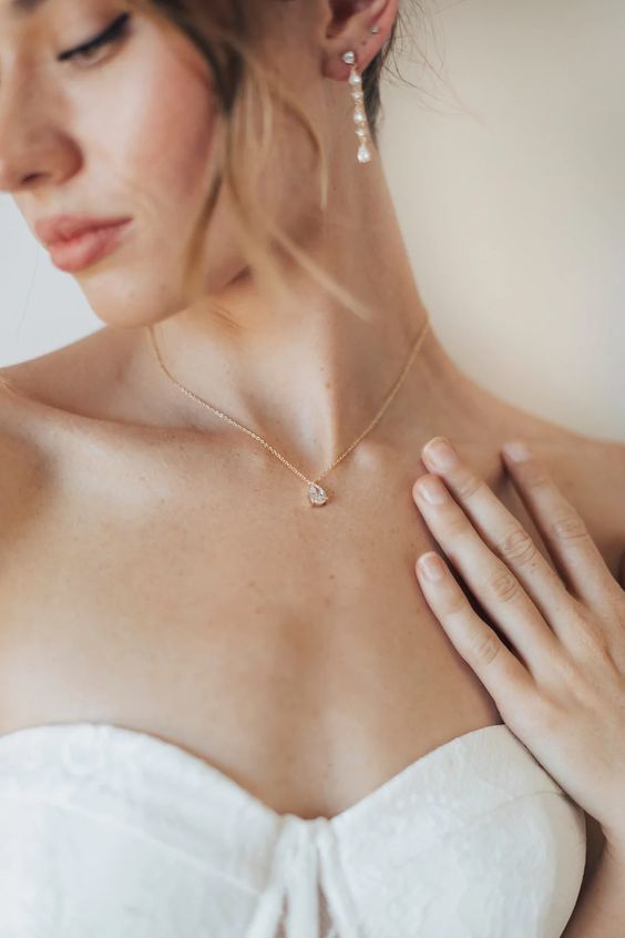 a tear drop shaped pendant on a delicate gold chain and pearl earrings will perfectly finish off your feminine bridal look