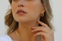 layered gold necklaces, pretty hoop earrings and a gold bracelet are cool jewelry to accessorize your casual bridal look
