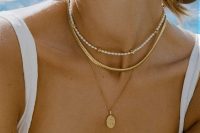 layered necklaces, a gold, a gold coin one and a delicate pearl choker are a great combo for a chic modern bridal look