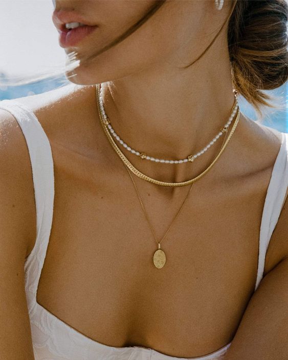 layered necklaces, a gold, a gold coin one and a delicate pearl choker are a great combo for a chic modern bridal look
