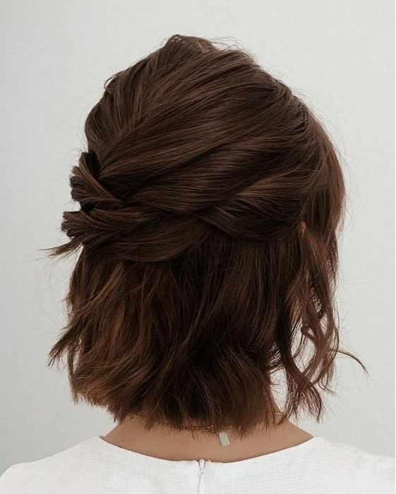 a modern half updo with several twists on top and a bump, with some waves down is a cool idea for a romantic look