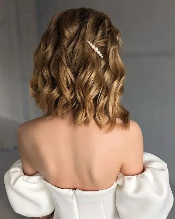 a lovely golden blonde wavy bob with a single pearl hair pin is a gorgeous idea for a wedding, it looks very cool