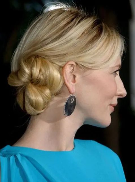 a blonde side low bun with a sleek top is a timeless hairstyle, it's a fresh and modern take on a classic bun