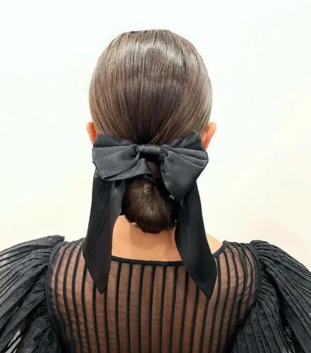 a bow tied chignon is a polished and chic idea, go for a satin or velvet bow according to your look and style