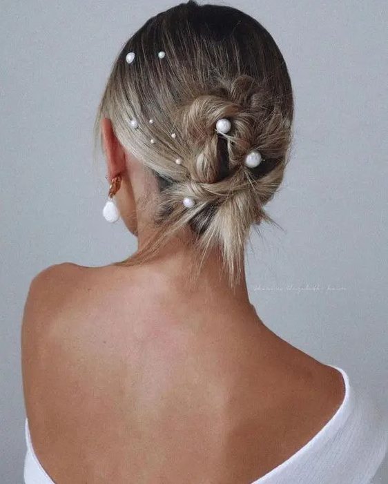 a messy twisted updo on medium-length hair with multiple pearl hair pins is a cool solution if your hair isn't long enough