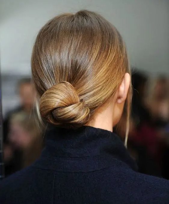 a very sleek twisted low bun with no hairpieces for a chic ultra-minimalist bridal look