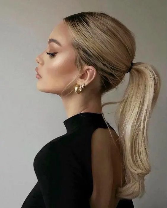 an elegant and chic wavy ponytail with a bump on top and waves is a lovely idea for a modern and stylish bridal look