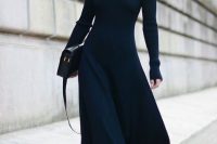 a black A-line midi sweater dress, booties and socks, a black bag and statement earrings for work or a date