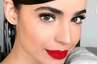 a bold winter wedding makeup with a perfect red lip, eyelash extensions, bushy eyebrows and a touch of shine