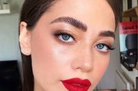 a catchy holiday makeup with a red lip, perfect tone with blush, fluffy eyebrows and shiny metallic eyeshadow