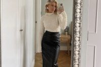 a catchy winter guest look with a black leather midi skirt, a textured top, bow shoes and statement earrings