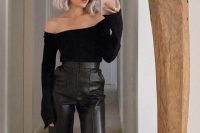 a classy guest outfit with a black off the shoulder top, black leather pants, strappy shoes and statement earrings