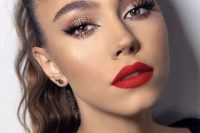 a glam holiday wedding makeup with a matte red lip, perfect tone with a touch of blush, lash extensions and pink metallic eyeshadow