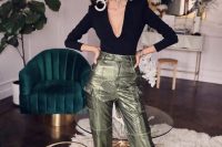 a jaw-dropping look with a black top with a plunging neckline, metallic green pants, black shoes and statement earrings
