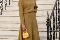 a lovely and comfortable work look with a mustard jumper and an A-line midi skirt, snakeskin print boots and a yellow bag