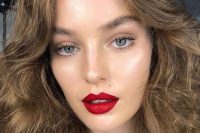 a lovely red lip makeup with a bold red lip, highlighter and a perfect tone plus accented eyebrows for the wedding