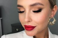 a matte holiday wedding makeup with a matte red lip, a matte skin tone, fluffy eyebrows and lash extensions