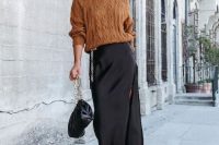 a pretty and classy winter wedding look with a brown turtleneck sweater, a black maxi skirt with a slit, black shoes and a bag