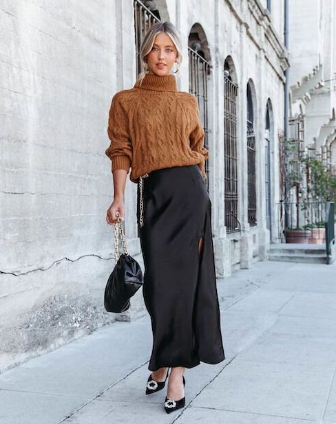 a pretty and classy winter wedding look with a brown turtleneck sweater, a black maxi skirt with a slit, black shoes and a bag