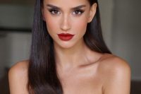 a refined holiday makeup with a red lip, perfect tone with blush, statement eyebrows and wings