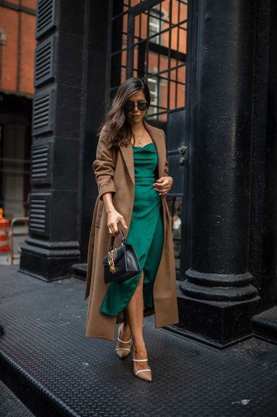 a stylish winter guest look with a green midi dress, nude shoes, a brown midi coat and a black bag
