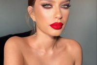 very eye-cathcy holiday wedding makeup with a red lip, a touch of blush, pink eyeshadow, lash extensions and a touch of highlighter