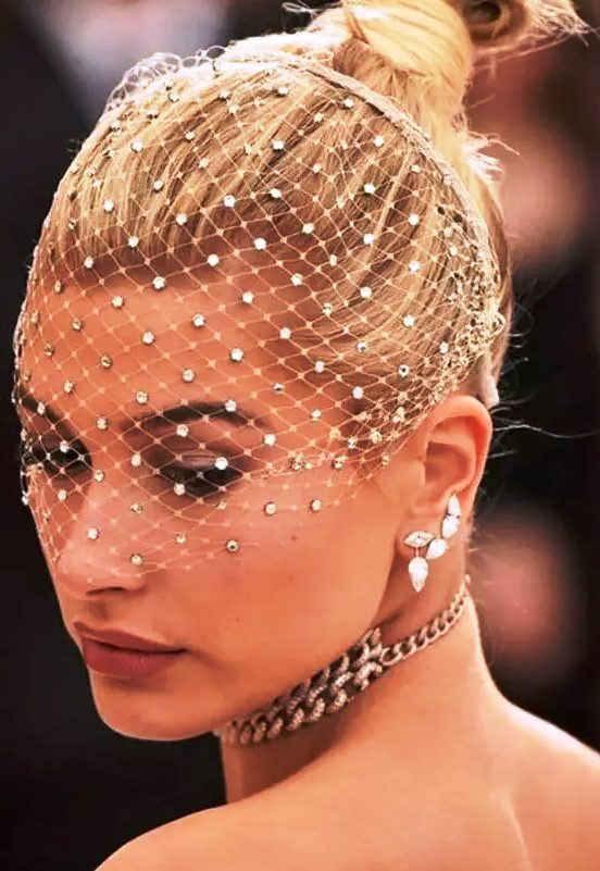 a birdcage veil with crystals is a bold and catchy solution to rock at a wedding, it will add drama to your look