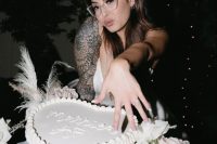 03 a modern white heart-shaped wedding cake with a cool inscription is a fun idea for a modern wedding