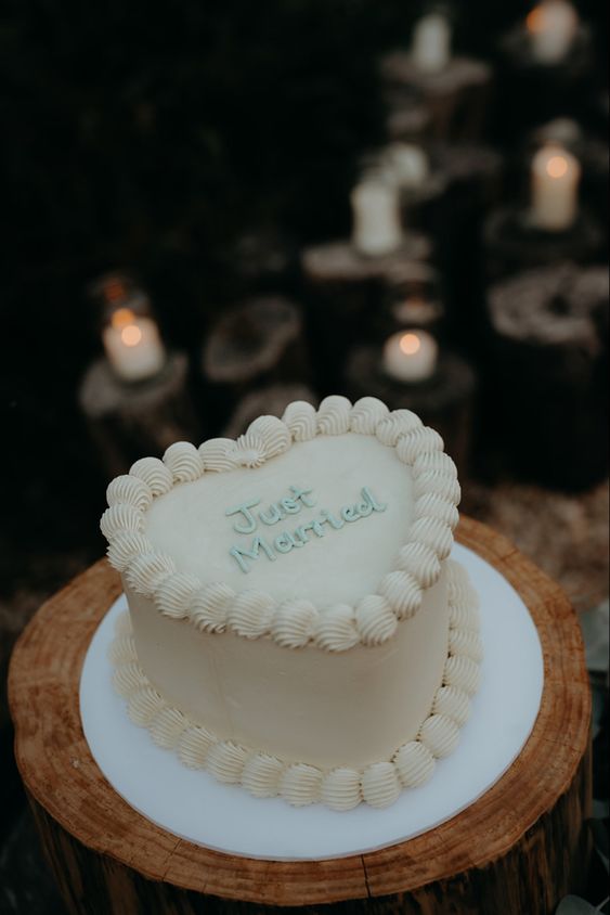 a simple white lambeth wedding cake with mint calligraphy is a cool idea for a modern wedding