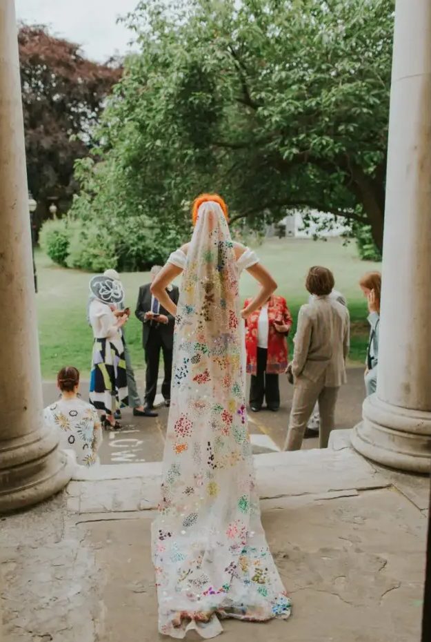 A statement colorful veil with embroidery, sequins and in bold colors is a unique accessory for a color loving bride