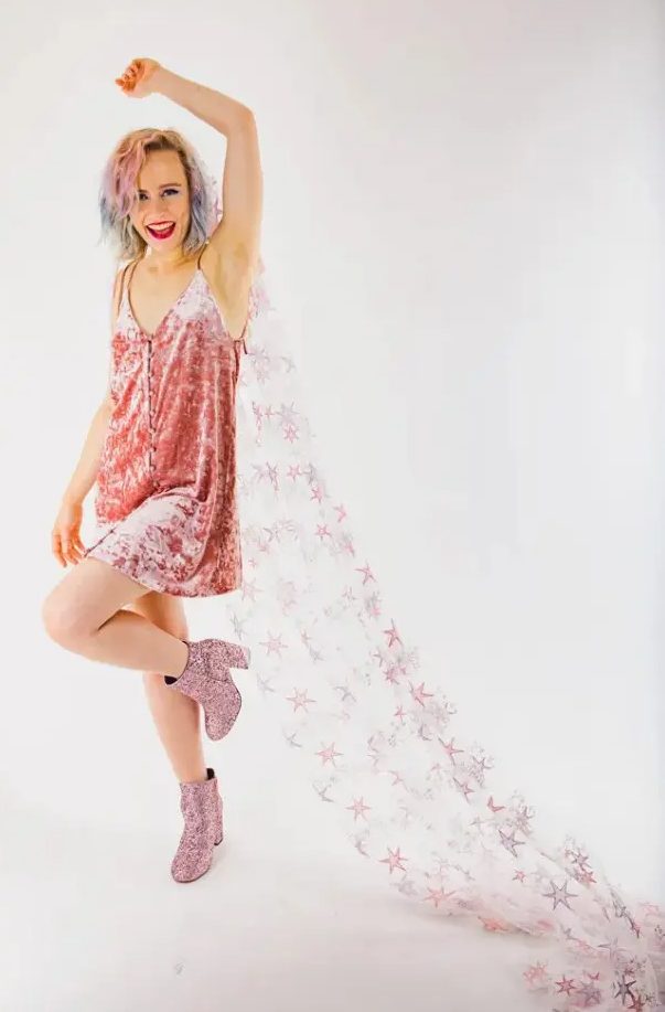 a rock n roll bride wearing a pink velvet dress, pink glitter boots and a pink and purple star veil as a bold accessory