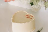08 a super simple white heart-shaped wedding cake with monograms is always a good idea for a casual wedding